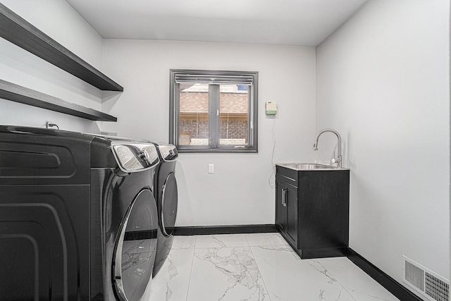 53242 Clarion Dr, Macomb, MI 48042 - clothes washing area featuring washing machine and clothes dryer, light marble finish floors, and baseboards