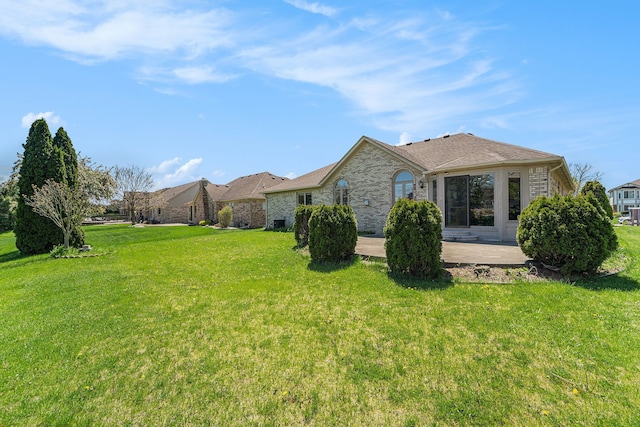 53242 Clarion Dr, Macomb, MI 48042 - view of side of property featuring a yard, a patio, and brick siding
