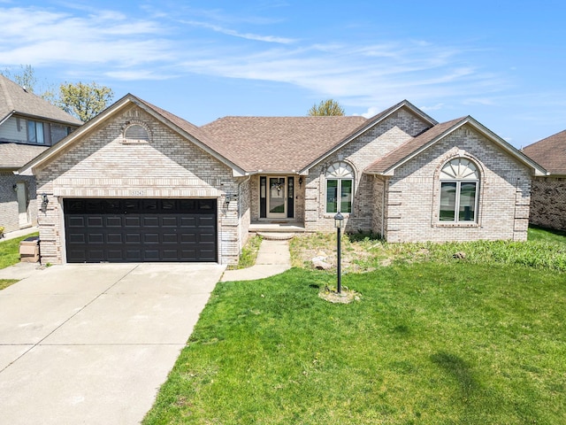 53242 Clarion Dr, Macomb, MI 48042 - view of front of home with an attached garage, brick siding, a front lawn, and driveway