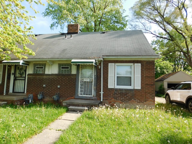 19835 Moross Rd, Detroit, MI 48224 - view of front of house featuring brick siding, a chimney, and a shingled roof