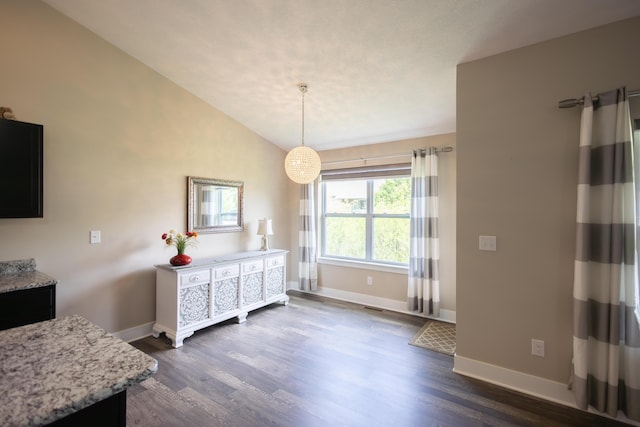 dining area with baseboards, dark wood-style flooring, and lofted ceiling