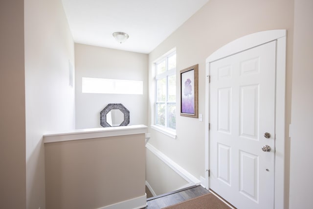 foyer featuring baseboards and wood finished floors