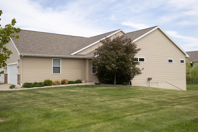 view of property exterior with a lawn, a shingled roof, and an attached garage