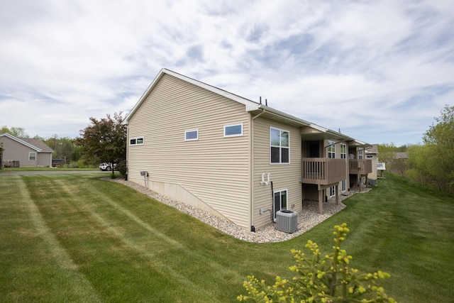 view of home's exterior featuring a yard, central AC, and a wooden deck
