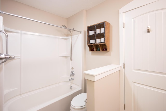 bathroom featuring shower / bathtub combination and toilet