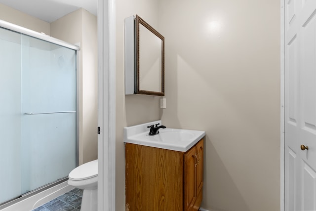 full bath with a stall shower, toilet, and vanity