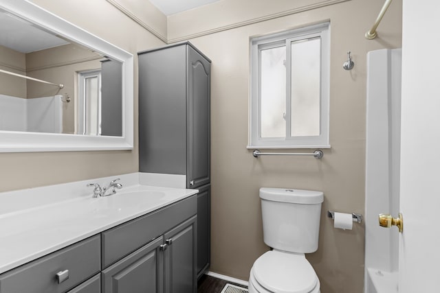 full bath featuring toilet, vanity, and a shower