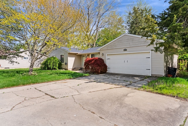 ranch-style home featuring an attached garage, driveway, and a front yard