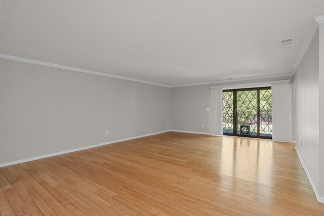 unfurnished room featuring ornamental molding, light wood finished floors, and baseboards