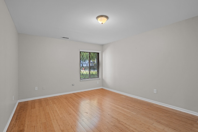 empty room featuring light wood-style flooring and baseboards