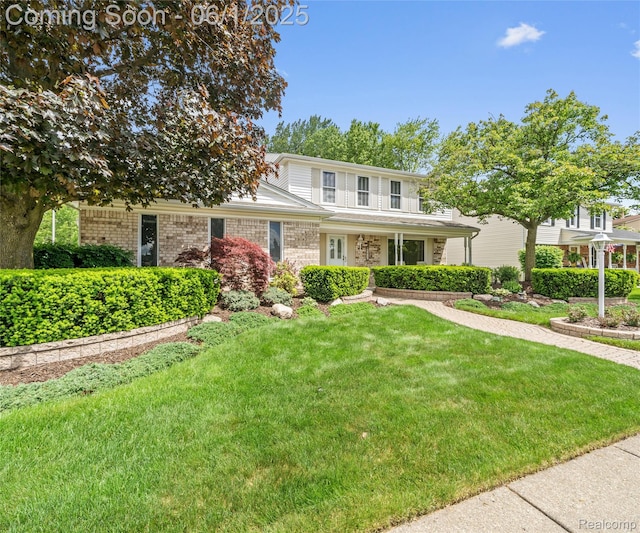 42736 Boulden Ct, Canton, MI 48187 - traditional-style house with a front yard, brick siding, and covered porch