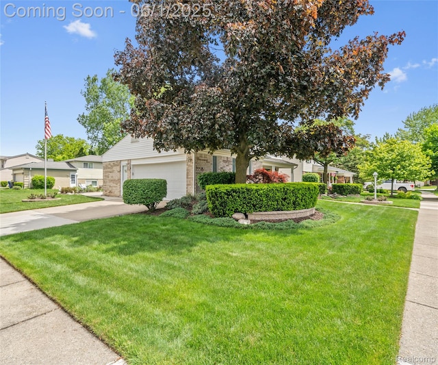 42736 Boulden Ct, Canton, MI 48187 - obstructed view of property with brick siding, a front yard, and concrete driveway