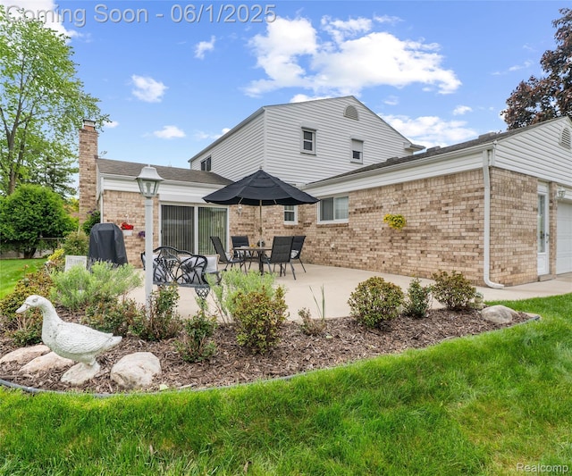 42736 Boulden Ct, Canton, MI 48187 - back of house featuring brick siding, an attached garage, a patio, and a chimney