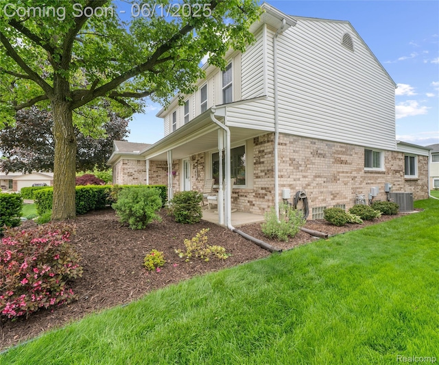 42736 Boulden Ct, Canton, MI 48187 - view of side of property featuring brick siding, central AC unit, and a lawn