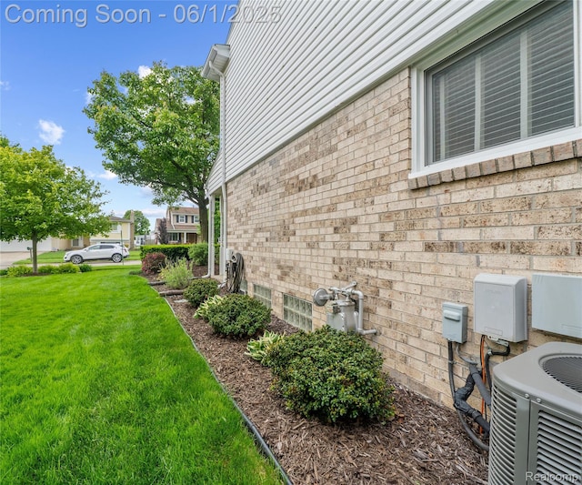 42736 Boulden Ct, Canton, MI 48187 - view of side of home featuring central AC, a yard, and brick siding