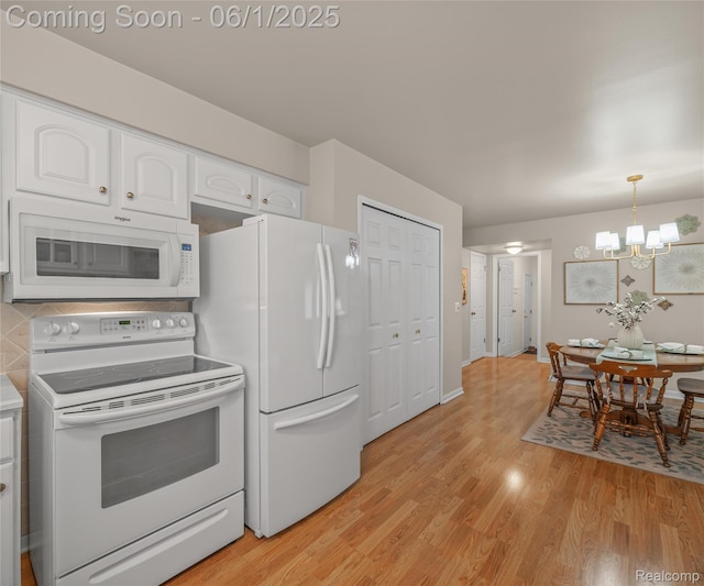 42736 Boulden Ct, Canton, MI 48187 - kitchen featuring white appliances, white cabinetry, light wood-type flooring, a chandelier, and pendant lighting