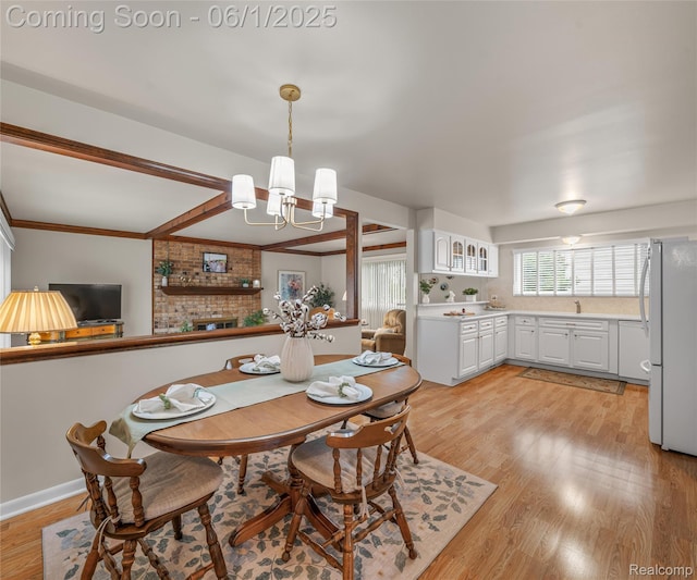 42736 Boulden Ct, Canton, MI 48187 - dining area with a chandelier, light wood-type flooring, and crown molding