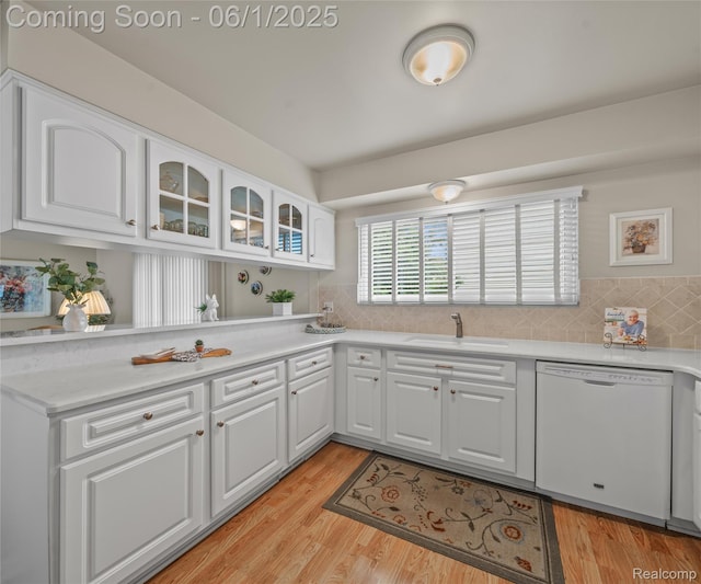42736 Boulden Ct, Canton, MI 48187 - kitchen featuring dishwasher, a sink, glass insert cabinets, light countertops, and white cabinetry