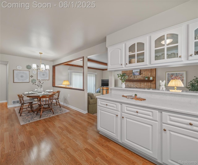 42736 Boulden Ct, Canton, MI 48187 - kitchen with baseboards, light countertops, white cabinets, and glass insert cabinets