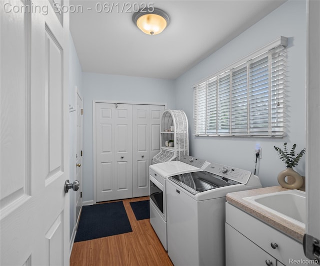 42736 Boulden Ct, Canton, MI 48187 - laundry area with washer and dryer, cabinet space, and light wood-type flooring