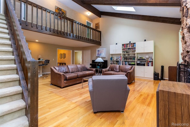 5423 Hauser Way W, Bloomfield, MI 48323 - living room with high vaulted ceiling, stairs, light wood finished floors, beam ceiling, and baseboards