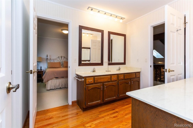 5423 Hauser Way W, Bloomfield, MI 48323 - ensuite bathroom featuring double vanity, wood finished floors, crown molding, and wallpapered walls