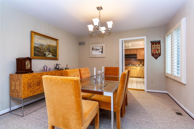 5423 Hauser Way W, Bloomfield, MI 48323 - dining space featuring light colored carpet, a chandelier, and baseboards