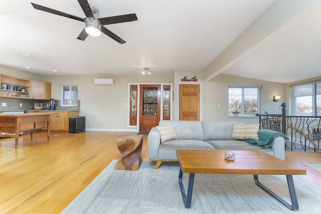6340 Sporny Dr, Brighton, MI 48116 - living room with a wall mounted air conditioner, light wood finished floors, a ceiling fan, baseboards, and beamed ceiling