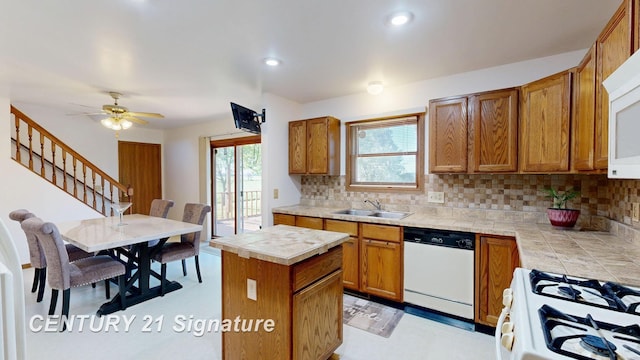 5530 Hess Rd, Saginaw, MI 48601 - kitchen with white appliances, decorative backsplash, tile countertops, brown cabinetry, and a kitchen island