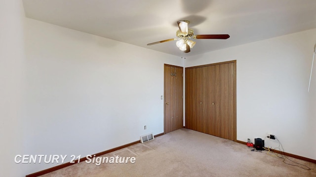 5530 Hess Rd, Saginaw, MI 48601 - unfurnished bedroom featuring light colored carpet, baseboards, a closet, and ceiling fan