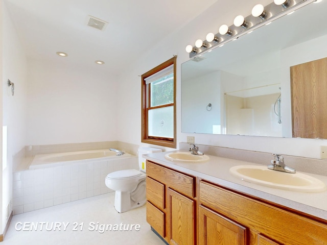 5530 Hess Rd, Saginaw, MI 48601 - bathroom with tiled bath, toilet, double vanity, and recessed lighting