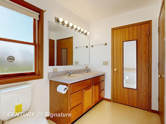 5530 Hess Rd, Saginaw, MI 48601 - full bathroom with healthy amount of natural light, double vanity, and toilet