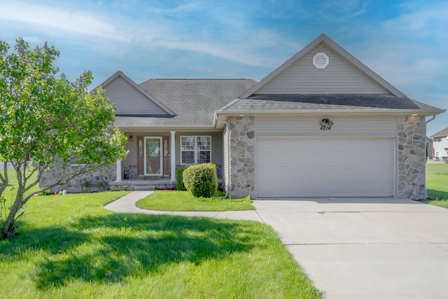 view of front of home featuring stone siding, a garage, a shingled roof, and a front yard