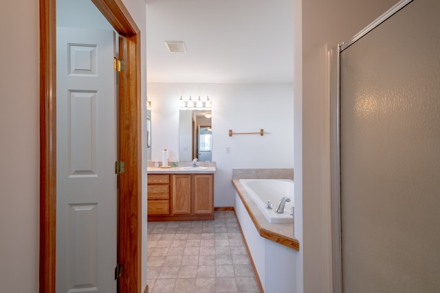 bathroom featuring a bath, vanity, and a stall shower