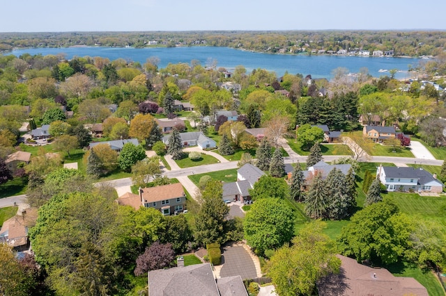 aerial view of residential area featuring a large body of water