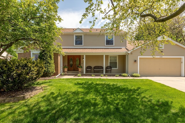 traditional-style home with a porch, a garage, concrete driveway, and a front yard