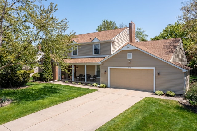 traditional-style home with a porch, a front yard, a garage, driveway, and a chimney