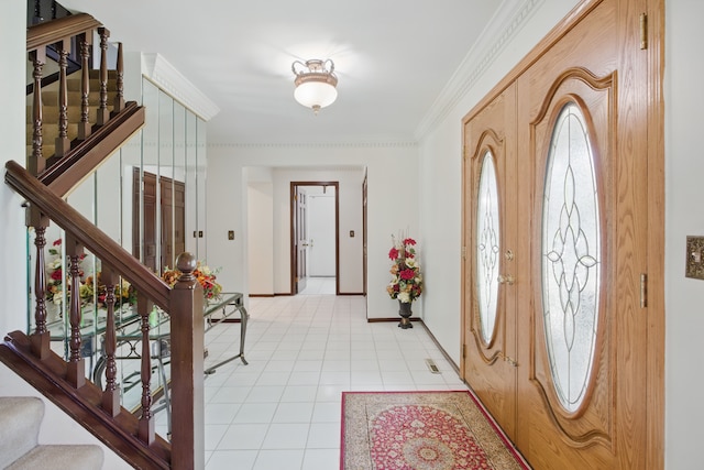 entrance foyer with stairs, baseboards, ornamental molding, and light tile patterned floors
