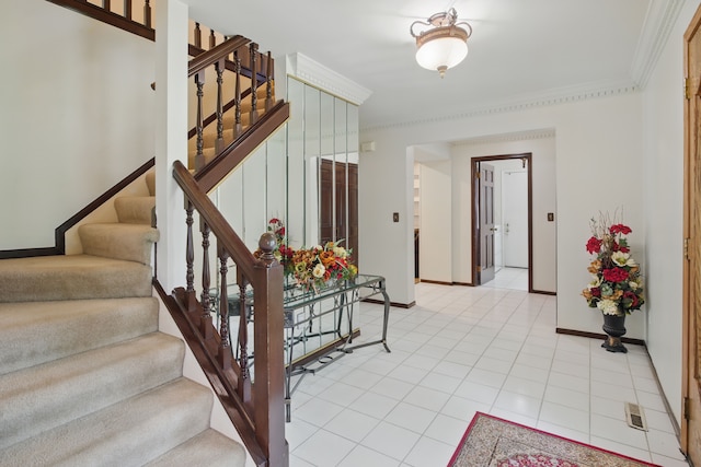entryway featuring stairs, crown molding, baseboards, and light tile patterned floors