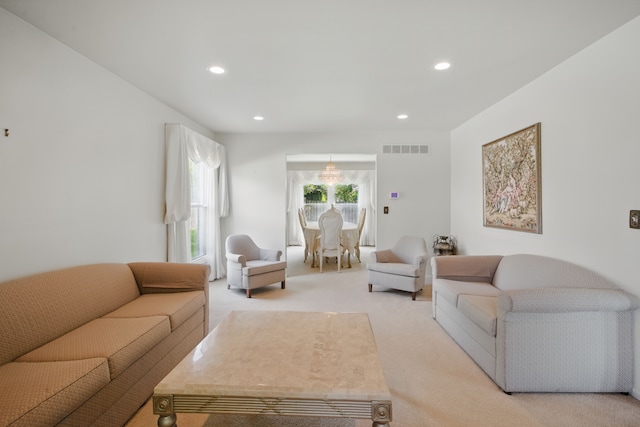 living room with light colored carpet and recessed lighting