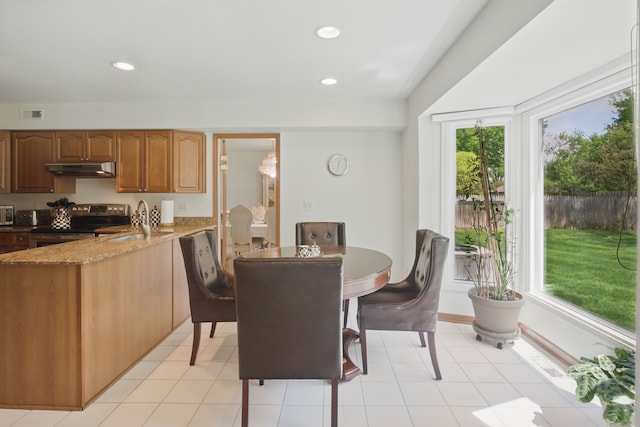 dining space featuring recessed lighting and light tile patterned floors