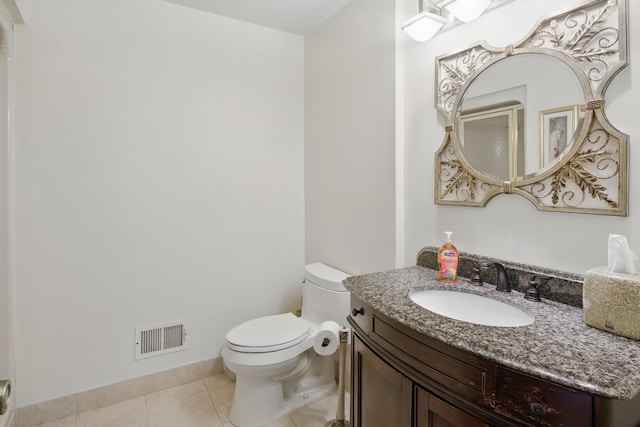 half bath with tile patterned floors, toilet, and vanity