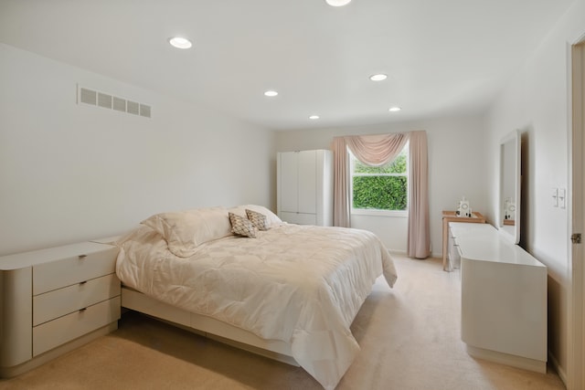 bedroom with recessed lighting and light carpet