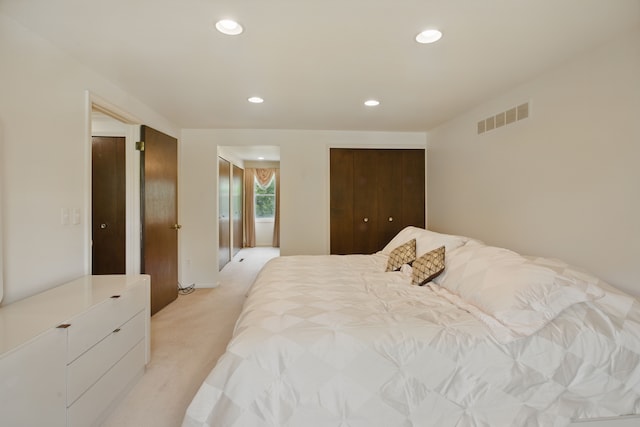 bedroom with light colored carpet and recessed lighting