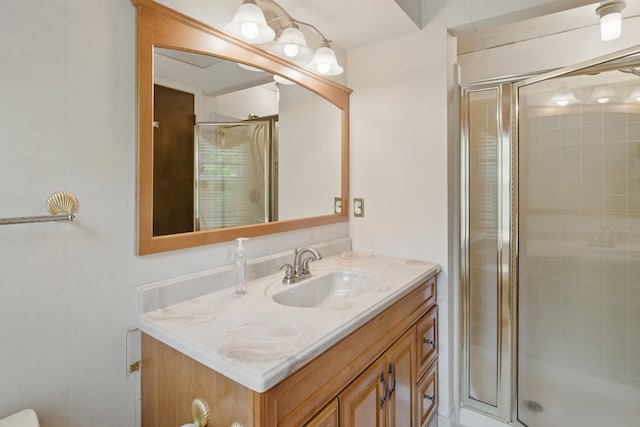 full bathroom with a stall shower and vanity
