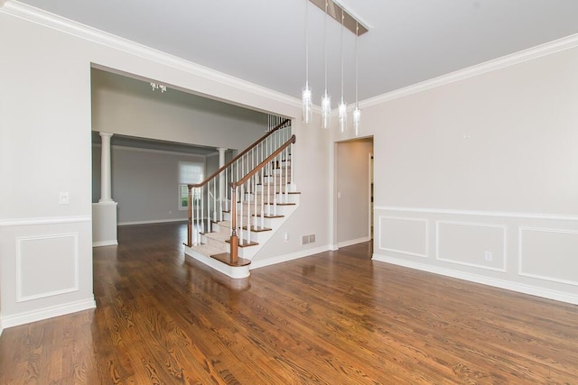 7294 Mackenzie Ln, Portage, MI 49024 - staircase featuring crown molding, wood finished floors, a decorative wall, and a wainscoted wall