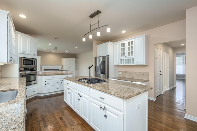 7294 Mackenzie Ln, Portage, MI 49024 - kitchen featuring stainless steel appliances, dark wood-style flooring, a kitchen island, white cabinets, and recessed lighting
