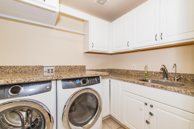 7294 Mackenzie Ln, Portage, MI 49024 - laundry room featuring washing machine and clothes dryer, cabinet space, and light tile patterned flooring