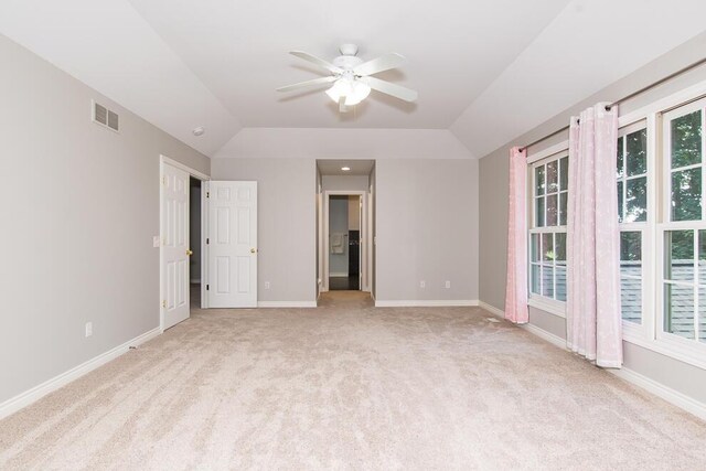 7294 Mackenzie Ln, Portage, MI 49024 - unfurnished bedroom featuring light colored carpet, baseboards, vaulted ceiling, and ceiling fan