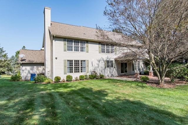 7294 Mackenzie Ln, Portage, MI 49024 - rear view of house featuring a chimney, a yard, a patio, and a shingled roof